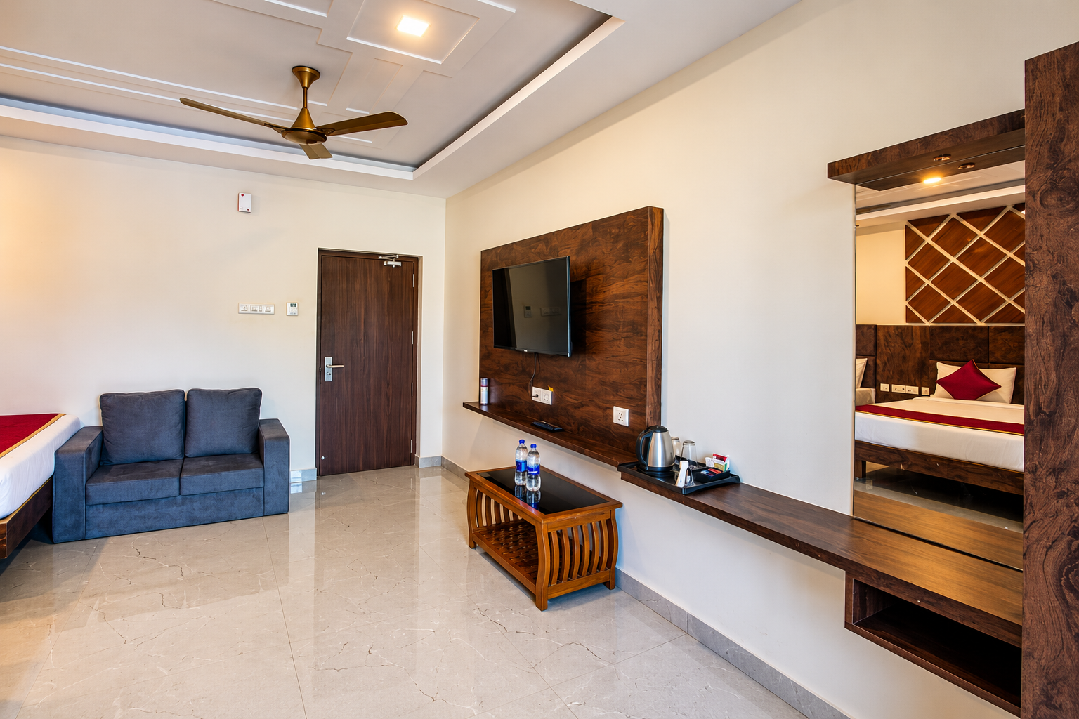 Modern hotel room with TV wall and vanity mirror